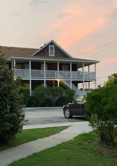 The Scarborough Inn, a shingled inn with wraparound porches in Manteo, North Carolina